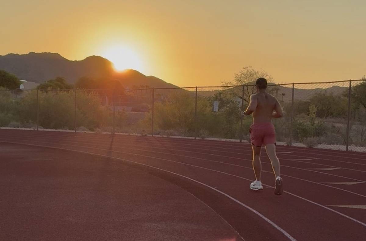 Runner on a track at sunrise