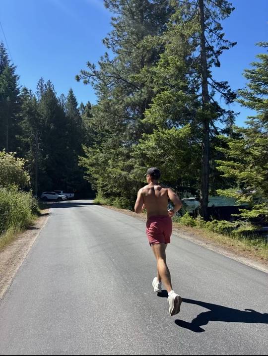 Runner on a tree-lined road